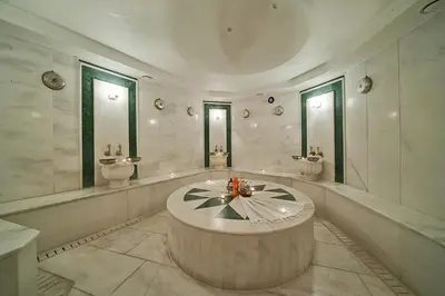 a large bathroom with a round table in the middle at The Byzantium Suites Hotel & Spa in Istanbul