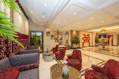 a living room with red chairs and a table at The Byzantium Suites Hotel & Spa in Istanbul