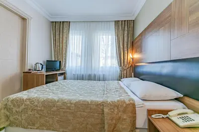 a hotel room with a bed and a telephone at Elasophia Hotel in Istanbul