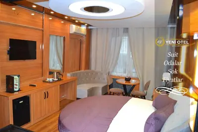 a hotel room with a bed and a tv at Gumus Palace Suites in Istanbul