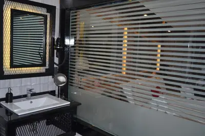 a bathroom with a sink and a window with blinds at Gumus Palace Suites in Istanbul