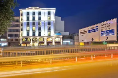 a building on the side of a highway at night at Grand Sagcanlar Hotel in Istanbul