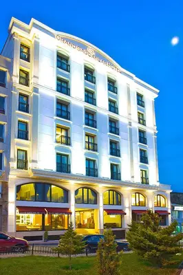 a large white building with cars parked in front of it at Grand Sagcanlar Hotel in Istanbul