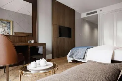 a bedroom with a bed and a table and a couch at Ramada Plaza By Wyndham Sultanahmet in Istanbul