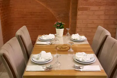 a wooden table with plates and napkins on it at Hotel Resitpasa Istanbul in Istanbul