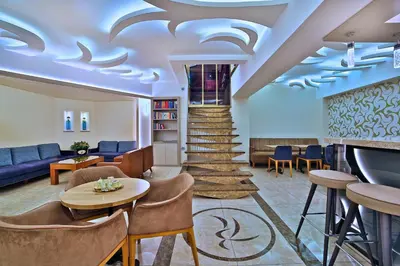 a lobby with a staircase and a living room at Hotel Resitpasa Istanbul in Istanbul