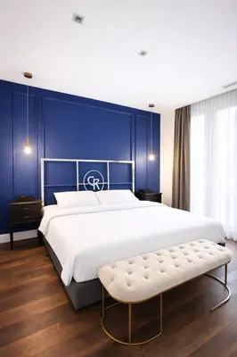 a bedroom with a large bed with a blue wall at Galateia Residence in Istanbul