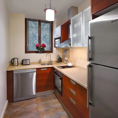a kitchen with wooden cabinets and stainless steel appliances at Galateia Residence in Istanbul