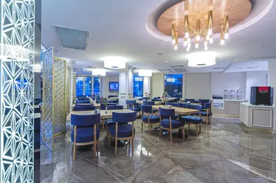a dining room with tables and blue chairs at History Hotel in Istanbul