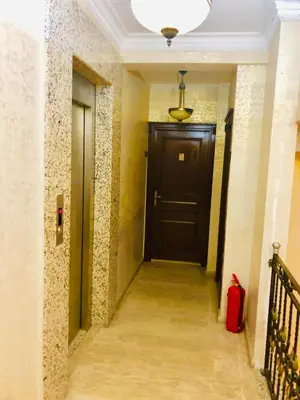 a hallway with a black door and a red suitcase at Art City Hotel Istanbul in Istanbul