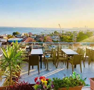 a patio with tables and chairs on a balcony at Art City Hotel Istanbul in Istanbul