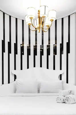 a bedroom with a black and white striped wall at Golden Pars Hotel in Bursa