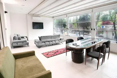 a living room with a table and chairs at Golden Pars Hotel in Bursa