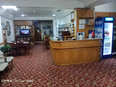 a large room with a bar and a dining room at Hotel Cesmeli in Bursa