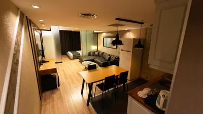 a living room and kitchen with a table and a couch at Mas Suites Nisantasi in Istanbul