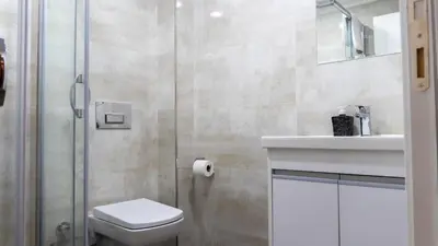 a bathroom with a toilet and a sink and a shower at Bursa Suites Apart Otel in Bursa