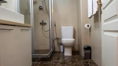 a small bathroom with a toilet and a shower at Bursa Suites Apart Otel in Bursa