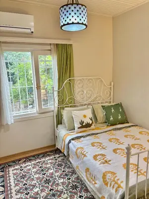 a bedroom with a bed and a window at Charming Anatolian House in Çengelköy in Istanbul