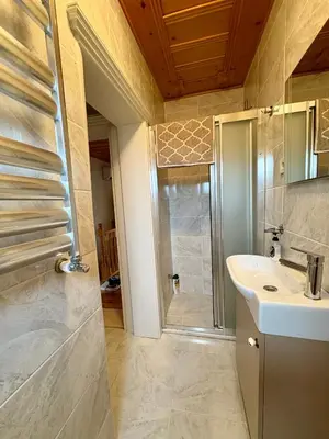 a bathroom with a sink and a shower at Charming Anatolian House in Çengelköy in Istanbul