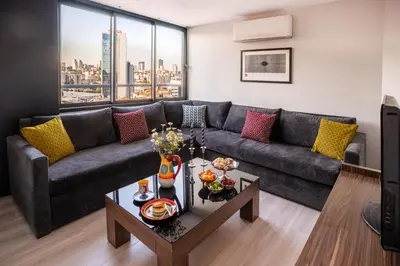 a living room with a couch and a table at Cheya Sisli BNB Medical & Business City Center Tesvikiye Suites and Apartments in Istanbul