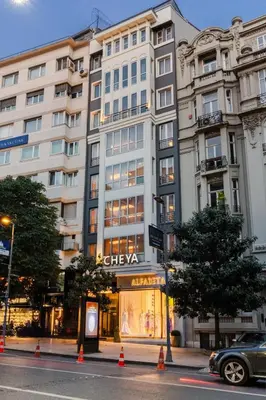 a large white building on a city street at Cheya Deluxe Residence Nisantasi Istanbul City Center in Istanbul