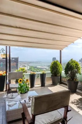 a balcony with a table and chairs and plants at Cheya Deluxe Residence Nisantasi Istanbul City Center in Istanbul