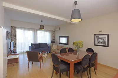 a dining room and living room with a table and chairs at Cheya Taksim BNB Gumussuyu Istanbul City Center Comfort Residence in Istanbul