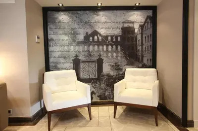 two white chairs in a room with a painting at Hotel La Villa in Istanbul