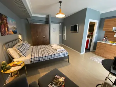 a bedroom with a bed and a living room at Flats Company - Karakoy Apartment in Istanbul