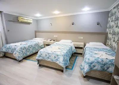 a hospital room with three beds in it at Fly Hotel in Istanbul