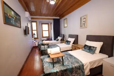 a room with two beds and a couch at The Trip istanbul Hotel in Istanbul