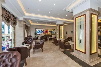a lobby with chairs and a piano in a building at Glorious Hotel in Istanbul