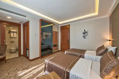 a hotel room with two beds and a bathroom at Glorious Hotel in Istanbul