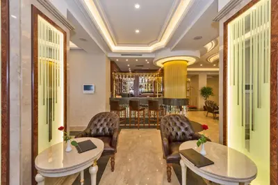 a lobby with two tables and chairs and a bar at Glorious Hotel in Istanbul