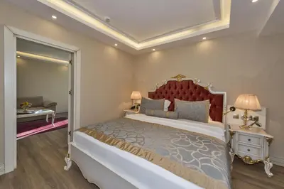 a bedroom with a large bed with a red headboard at Glorious Hotel in Istanbul