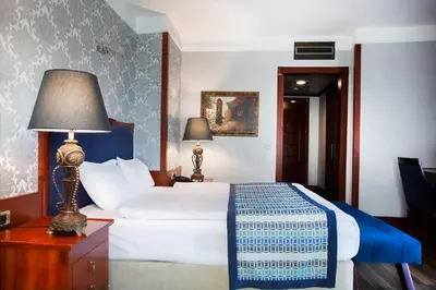 a bedroom with a bed and a lamp on a table at Boutique Princess Hotel in Istanbul