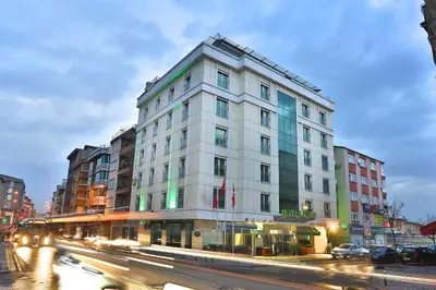 a tall white building on a city street with cars at Boutique Princess Hotel in Istanbul