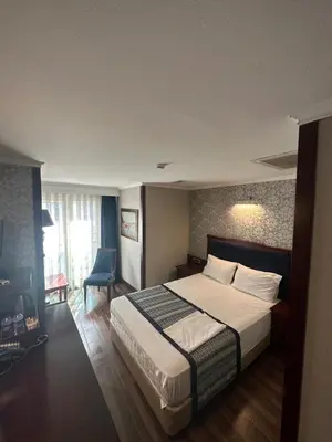 a hotel room with a bed and a chair at Boutique Princess Hotel in Istanbul
