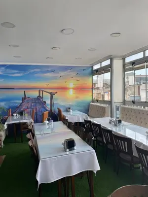 a restaurant with tables and chairs and a painting on the wall at Polanin Hotel in Istanbul