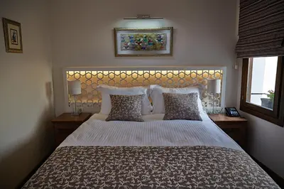 a bedroom with a large white bed with pillows at Arart Hotel in Istanbul