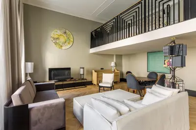 a living room with a couch and a tv at The Wings Hotels Collection in Istanbul