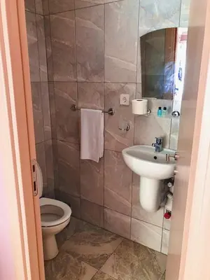 a bathroom with a toilet and a sink at Ozdemir Pansiyon in Heybeliada