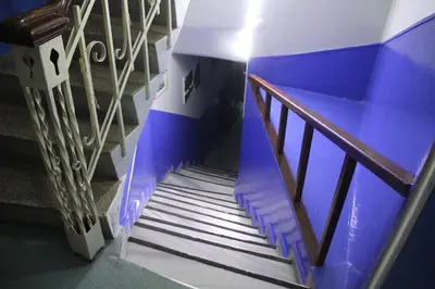 a spiral staircase with blue paint on the side at Ozdemir Pansiyon in Heybeliada