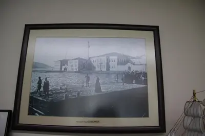 a framed picture of a town on a wall at Ozdemir Pansiyon in Heybeliada