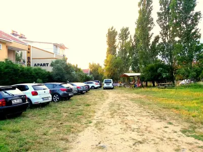 a row of cars parked on a dirt road at Sağlık Apart Pansiyon in Erdek