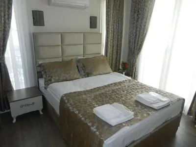 a bedroom with a bed with two towels on it at Best Home Suites Sultanahmet in Istanbul