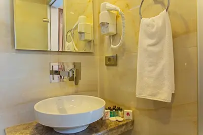a bathroom with a white sink and a towel at Grand Naki Hotel in Istanbul