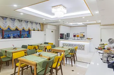 a restaurant with tables and chairs and a counter at Grand Naki Hotel in Istanbul