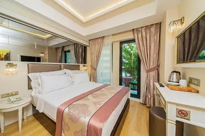 a hotel room with a bed and a kitchen at Grand Naki Hotel in Istanbul