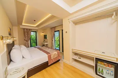 a bedroom with a large bed and a television at Grand Naki Hotel in Istanbul